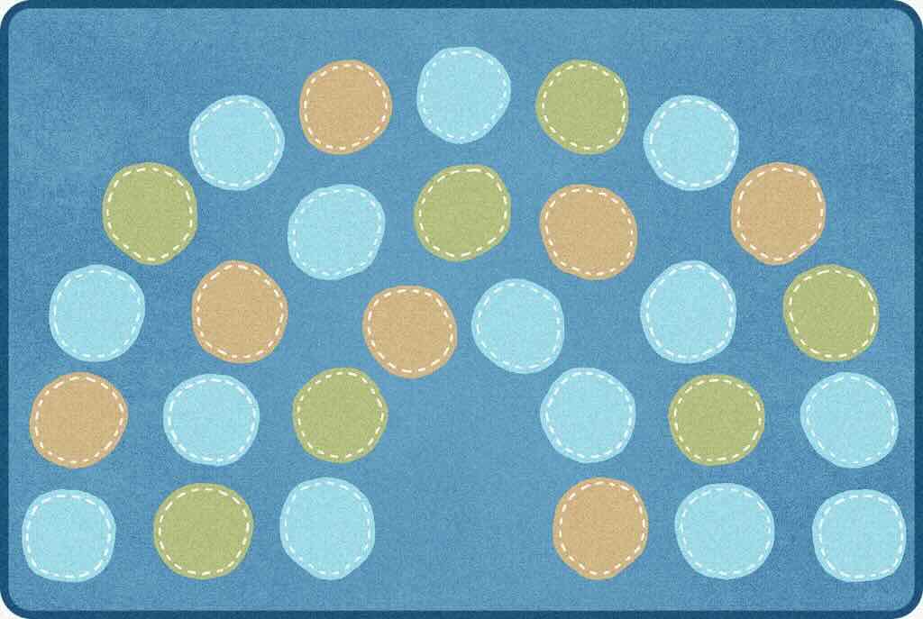 A soft blue carpet with circle arches in soft colors representing Sensory Carpets for kids